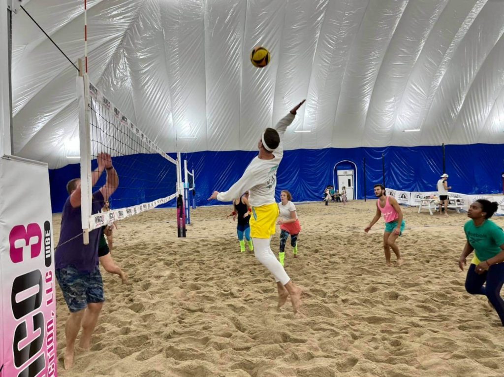 Sand volleyball team playing on indoor sand volleyball court
